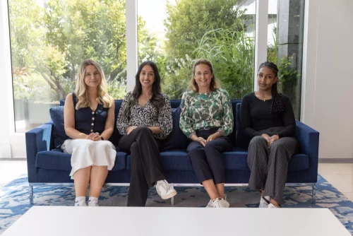 Early Careers team sitting on a sofa in a reception area.
