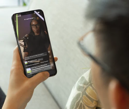 Aspiring solicitor watching the HL Legal Lounge Podcast on a smartphone.